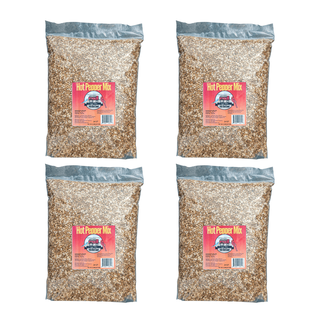 Four bags of JCS Wildlife Hot Pepper 5lb Loose Seed Bag, a spicy bird feed mix designed to deter mammals like squirrels and chipmunks.